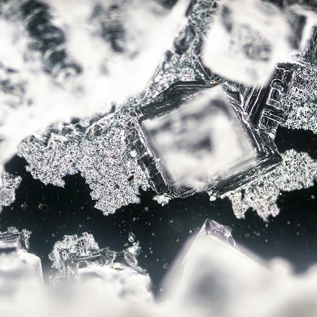 sodium chloride crystallization on black background under polarized light