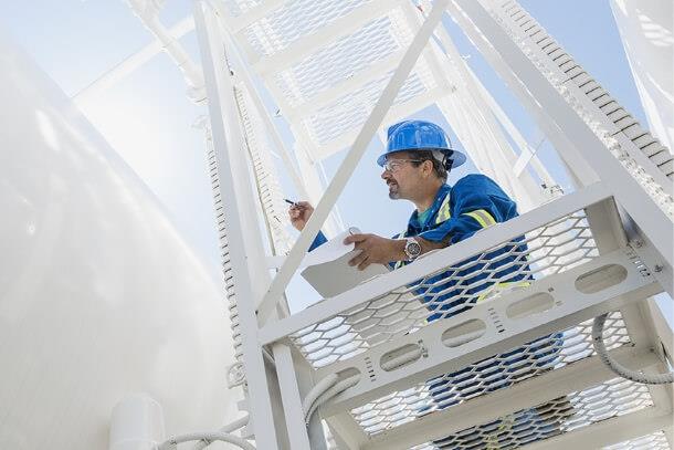 Engineer working on an industrial structure, symbolizing Nafion™'s role in hydrogen energy and membrane recycling