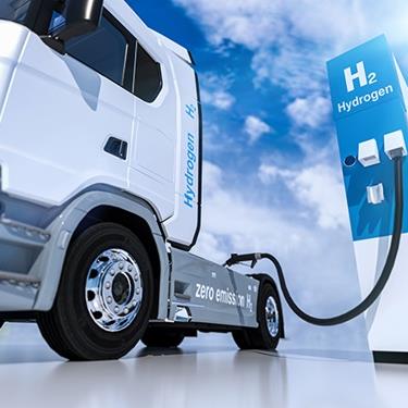 Fuel cell truck plugged into a hydrogen fuel pump