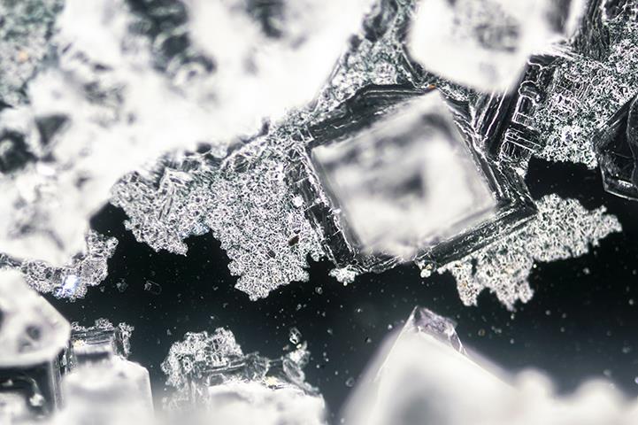 sodium chloride crystallization on black background under polarized light